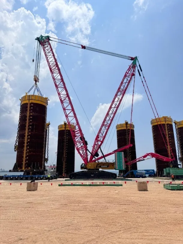 Crawler crane lifting a 25-metre suction pile from a barge at Jurong Port, Singapore
