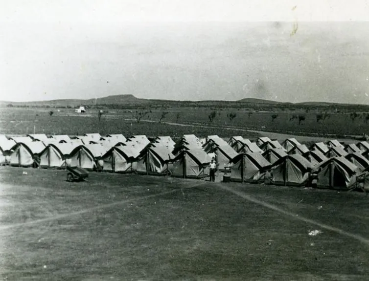 Historical mining camp tent cities with basic shared amenities